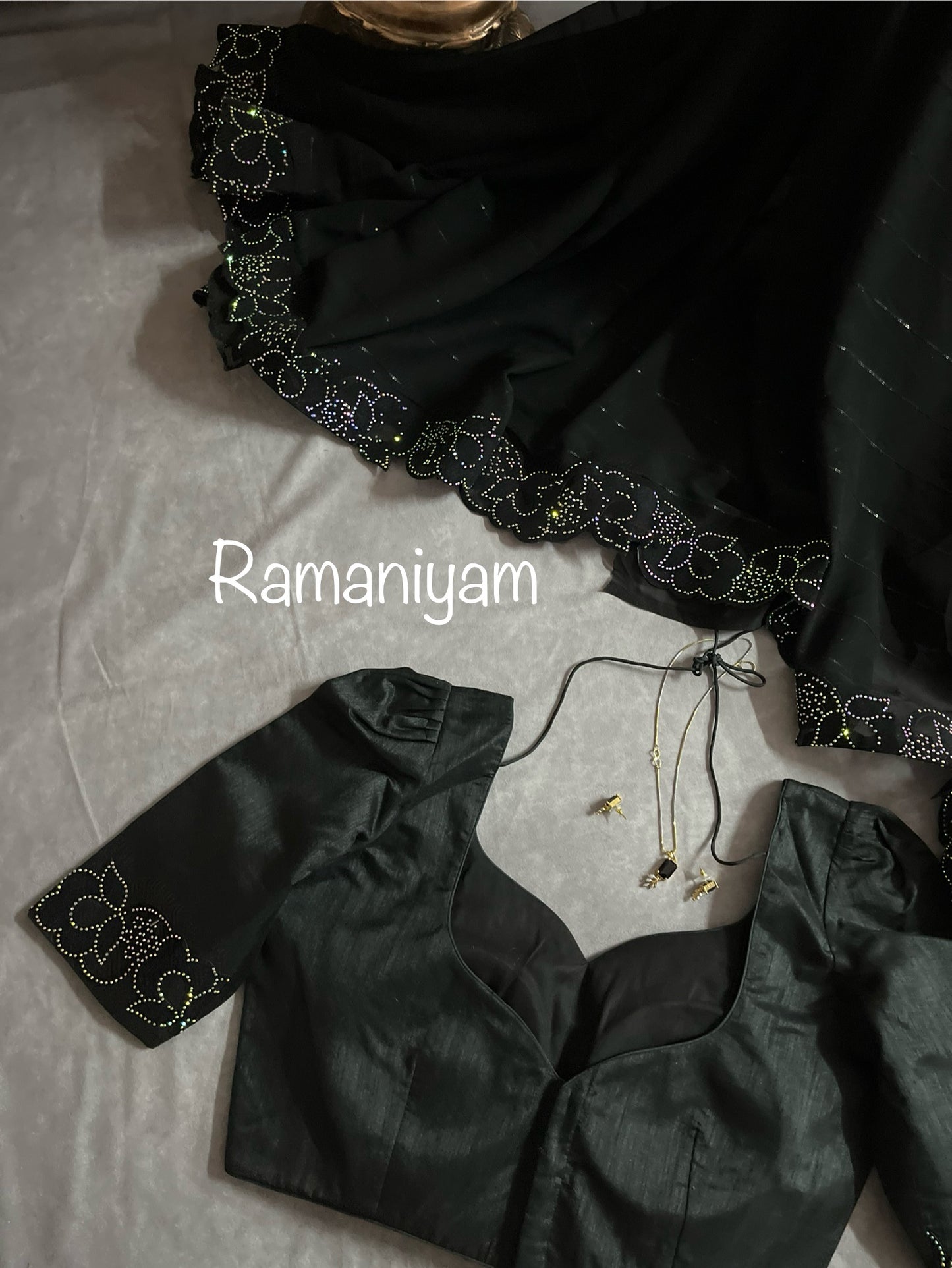 Party wear Black georgette saree featuring a beautiful cutwork border with crystal finishing