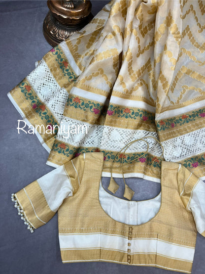 Off-white Banarasi saree adorned with mesmerizing meenakari and cutwork border