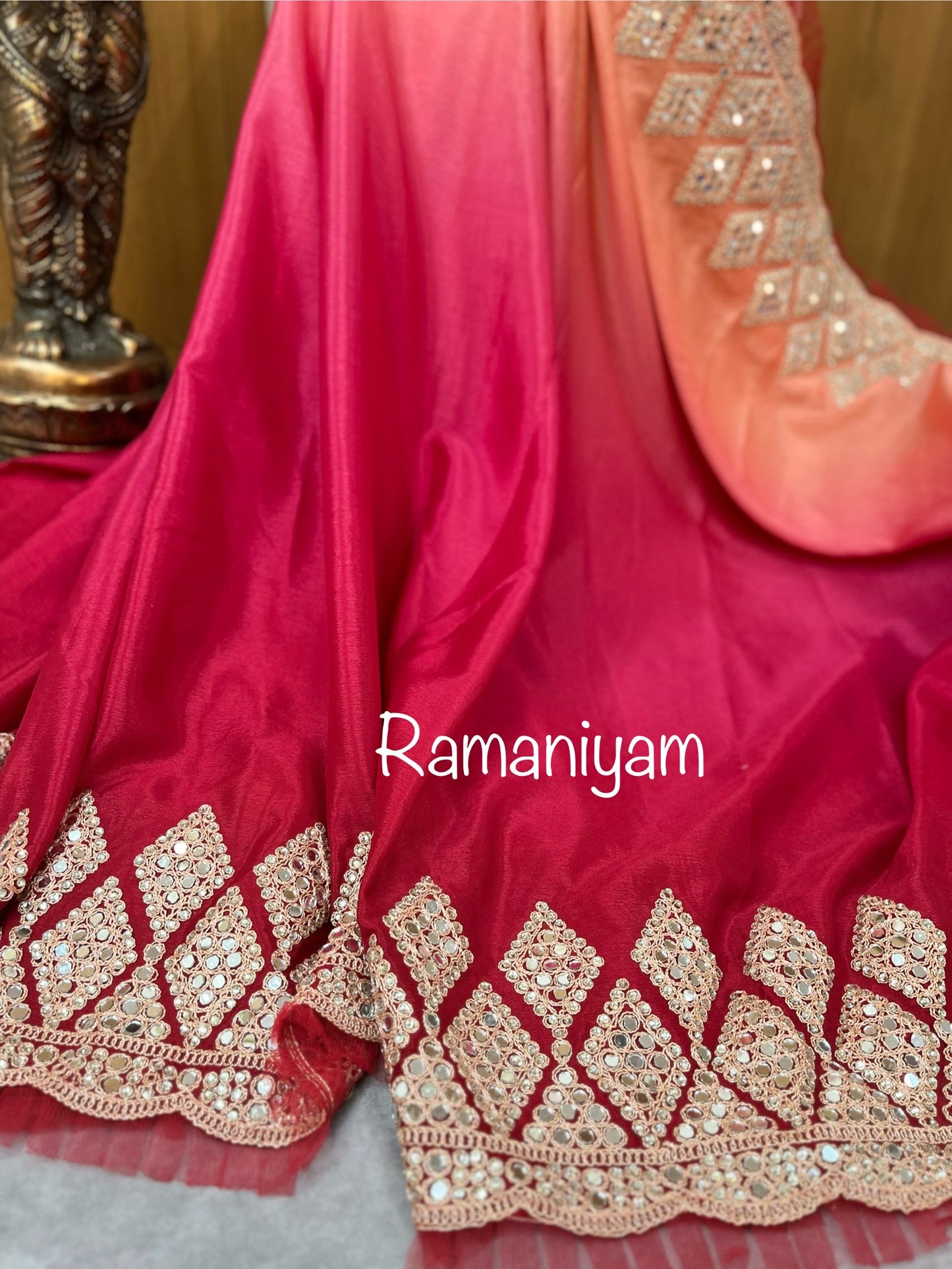 Party wear pink and red shaded crape silk saree embellished with intricate mirror work