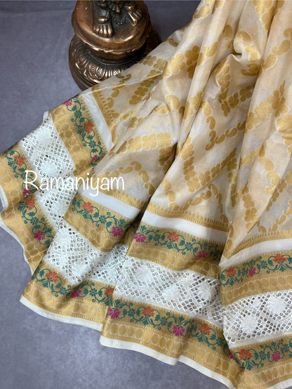 Off-white Banarasi saree adorned with mesmerizing meenakari and cutwork border