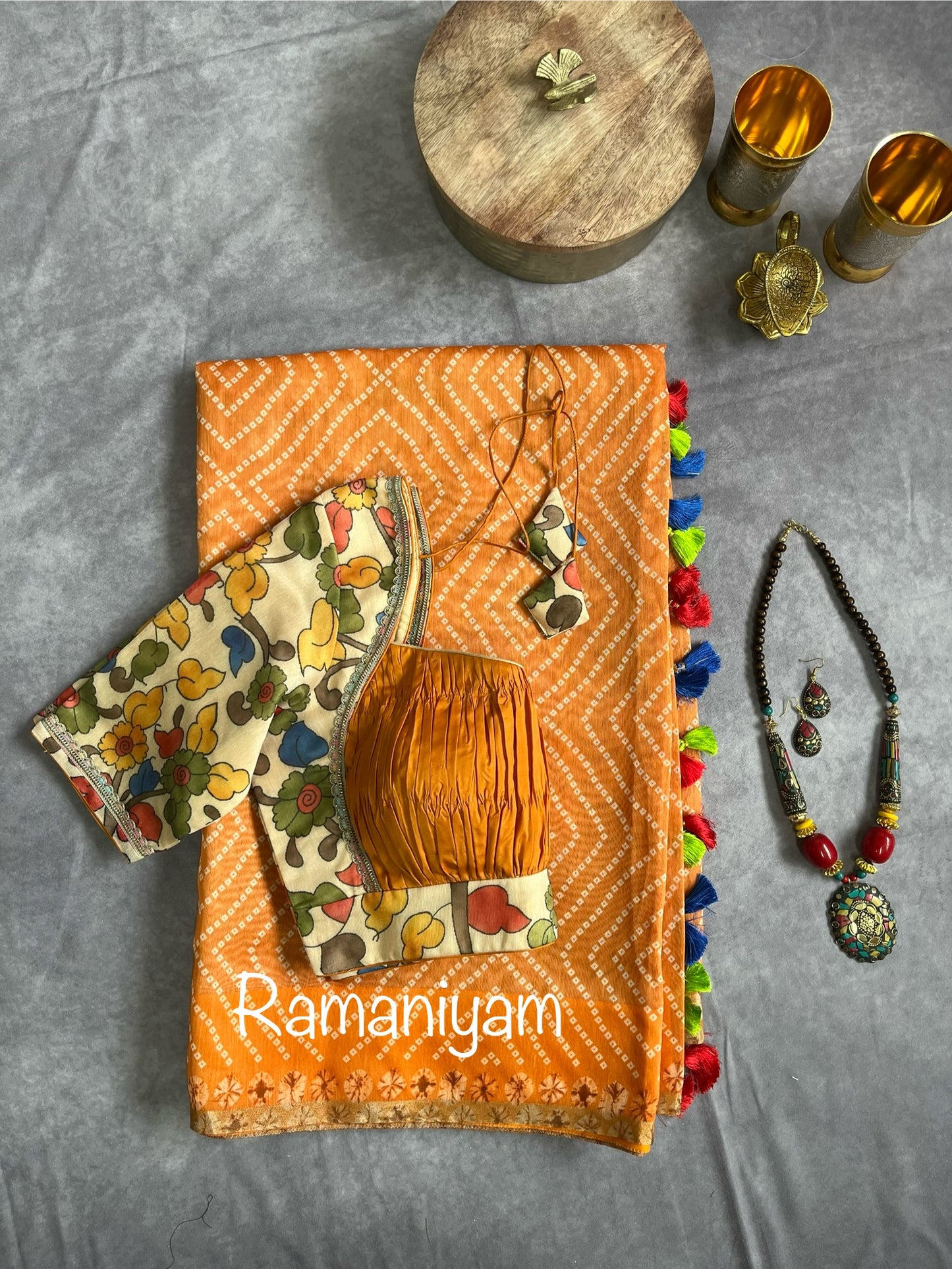 Mustard yellow Organza Bandhani saree with a Kalamkari pallu