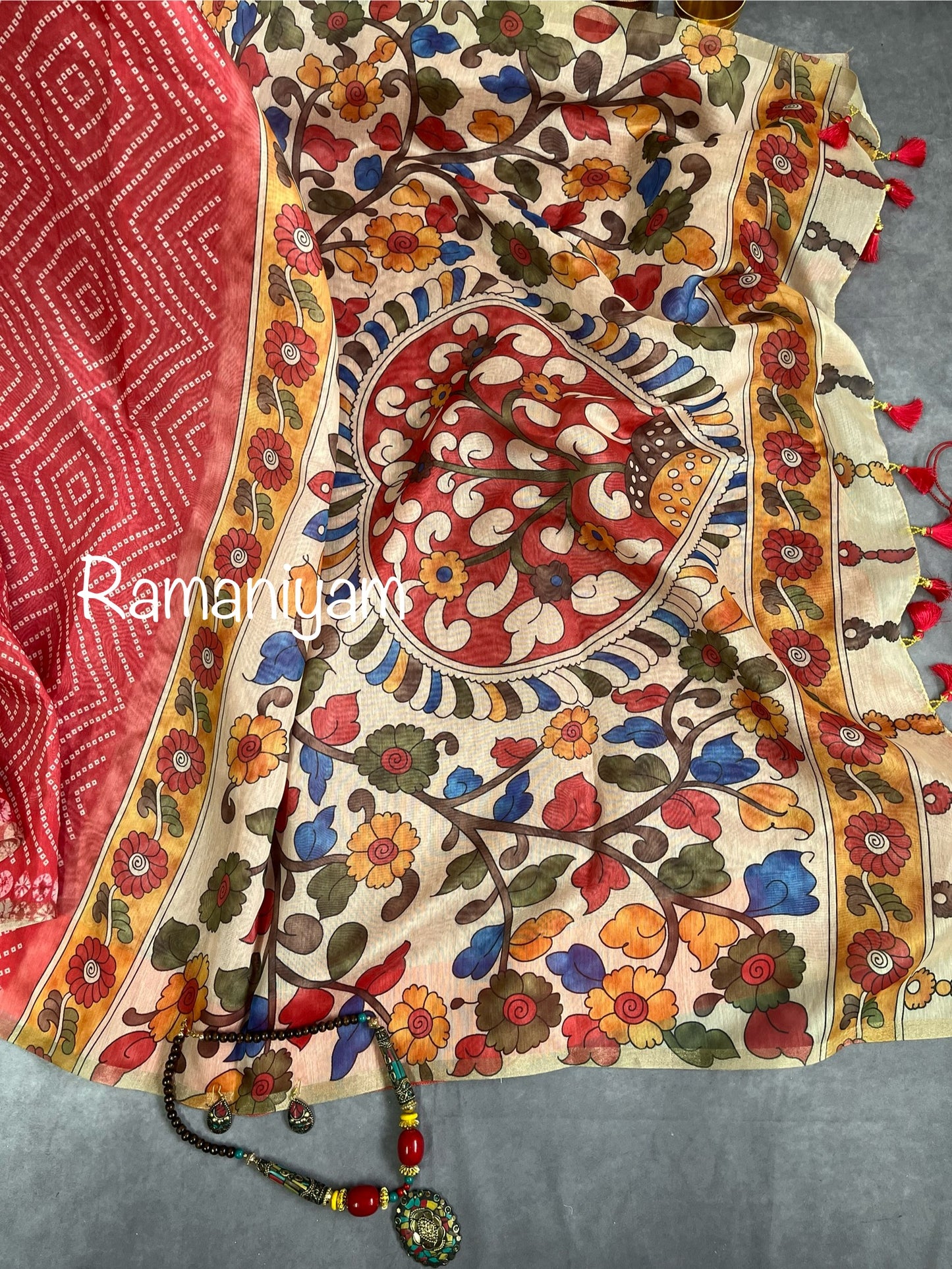 Peach red Organza Bandhani saree with a Kalamkari pallu