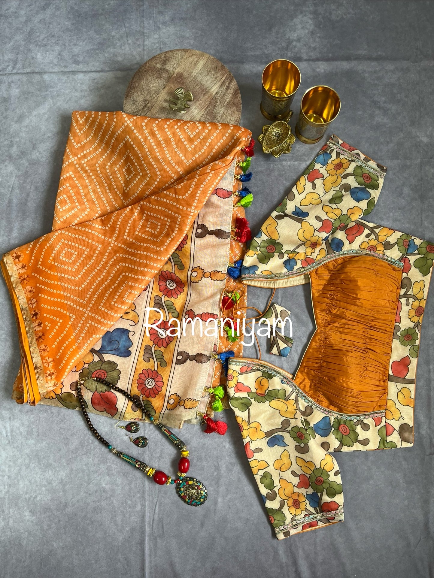 Mustard yellow Organza Bandhani saree with a Kalamkari pallu