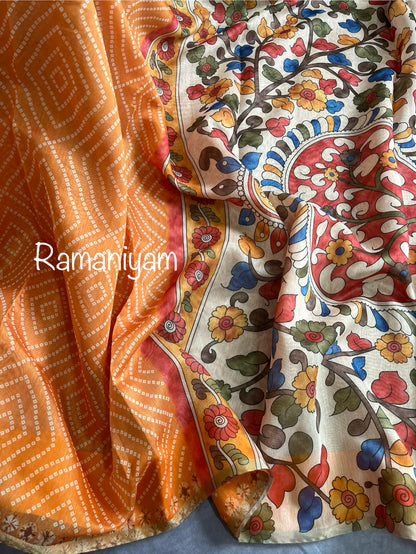 Mustard yellow Organza Bandhani saree with a Kalamkari pallu