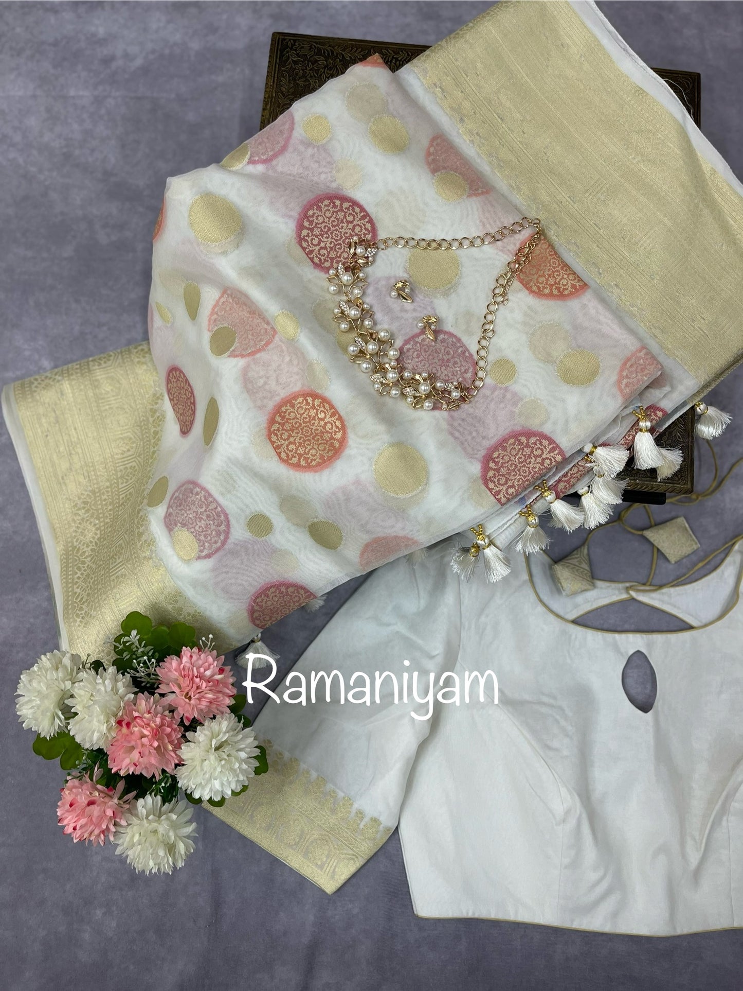 Offwhite Banarasi kora saree, adorned with intricate thread weaving and jari borders and pallu