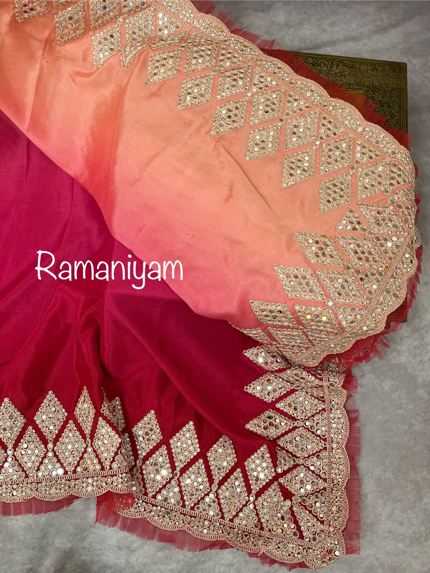 Party wear pink and red shaded crape silk saree embellished with intricate mirror work